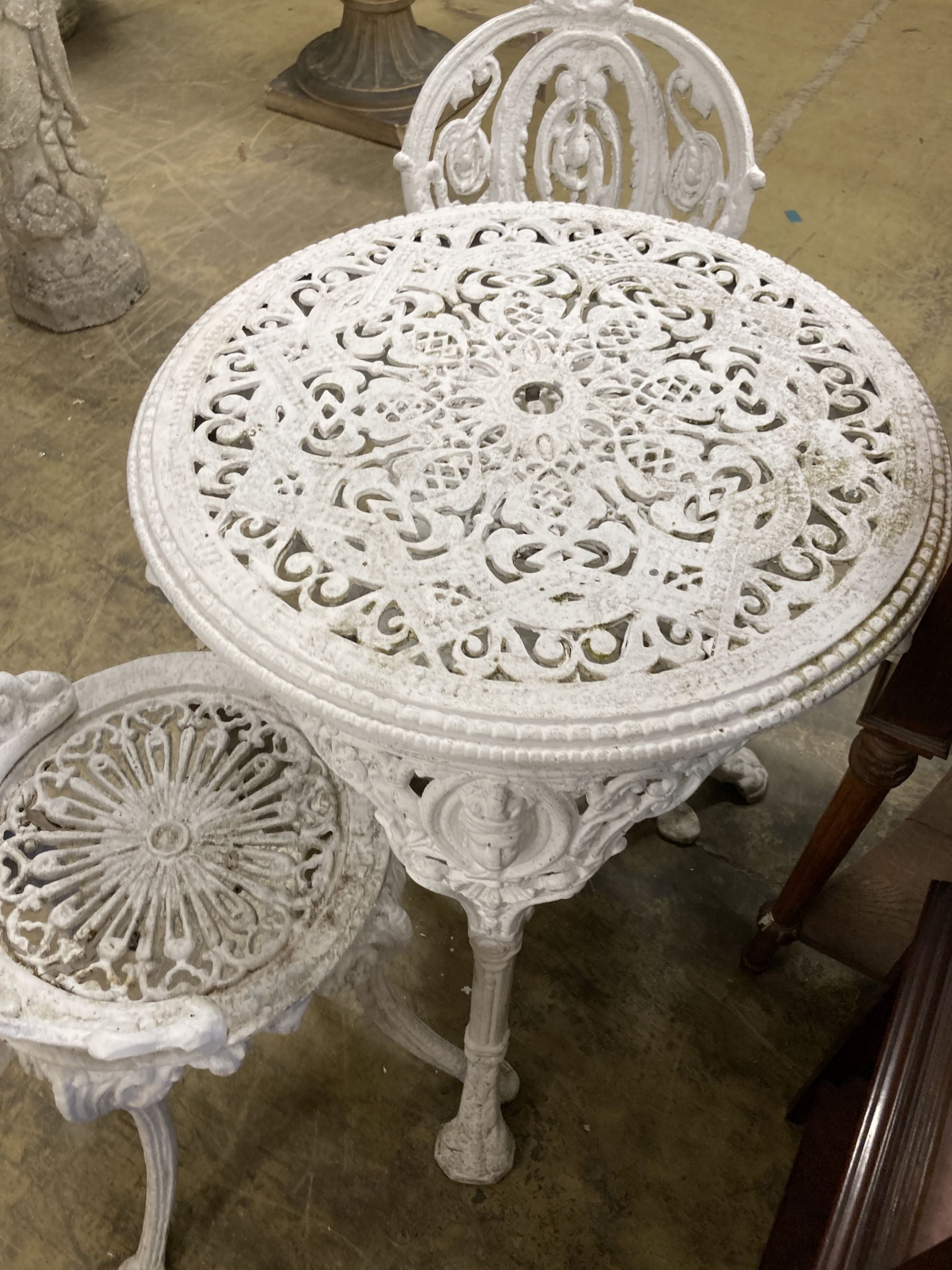 A Coalbrookdale style painted aluminium garden table, 59cm diameter, height 72cm and two chairs